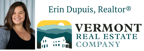 A headshot of Erin Dupuis, real estate agent, and logo for Vermont Real Estate Company. On the left hand side, an image of Erin who has olive skin and long dark brown hair. She is wearing a black shirt and gray sweater and is set against a gray paneled background. On the left, the words "Erin Dupuis, Realtor" are in dark teal above the word "Vermont" in black and "Real Estate Company" in dark teal. Next to the words, a white silhouette of a house is visible with mountains and a sunset above it. The mountains are varying shades of teal, the sky is yellow, and the setting sun is white.