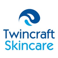 A logo for Twincraft Skincare. A dark blue water splash is visible at the top with a lighter, smaller splash of blue below. In dark blue text, the word Twincraft. In light blue text, the word Skincare.
